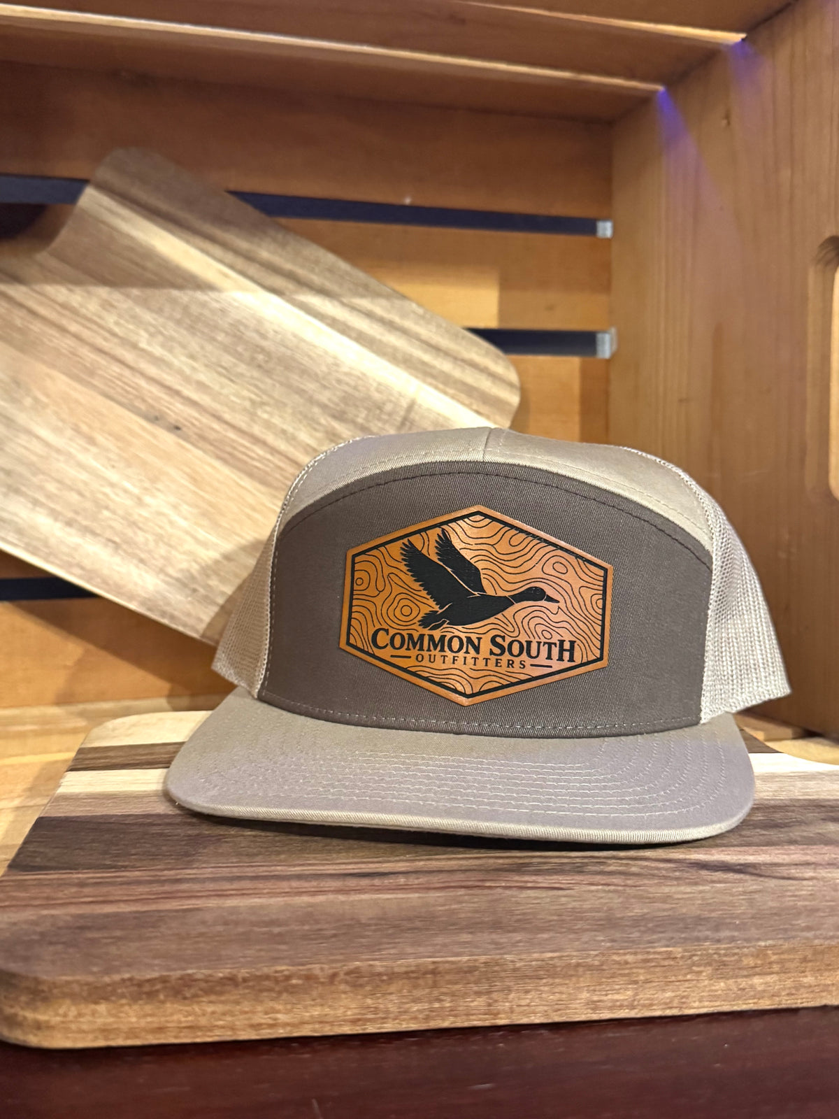 Common South Outfitters brown and khaki Richardson 7-panel trucker with topo duck leather patch